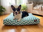 Corgi nestled into the soft Seabreeze chevron pillow bed in a sunlit room